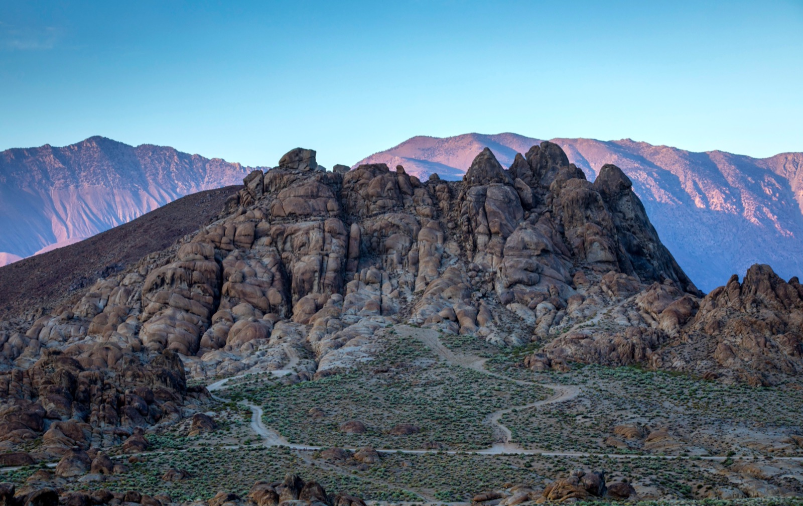 Rounded granite rock formations of the Alabama Hills below the Sierra Nevada at dawn
