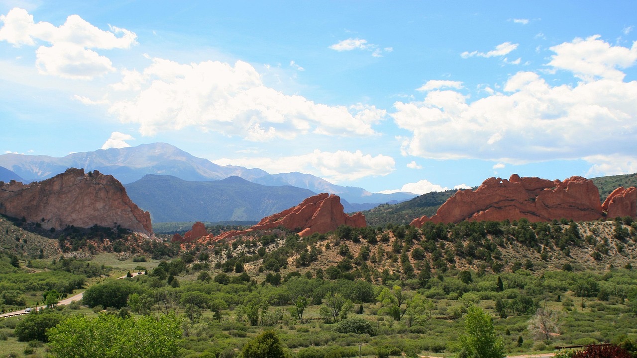 Red sandstone formations of Garden of the Gods with Pikes Peak behind them